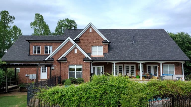 brick home with black sable duration shingles
