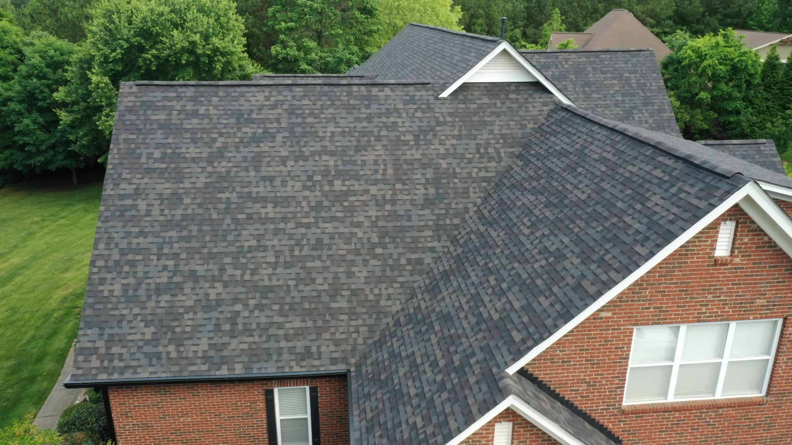 side aerial view of brick home with black sable duration shingles scaled