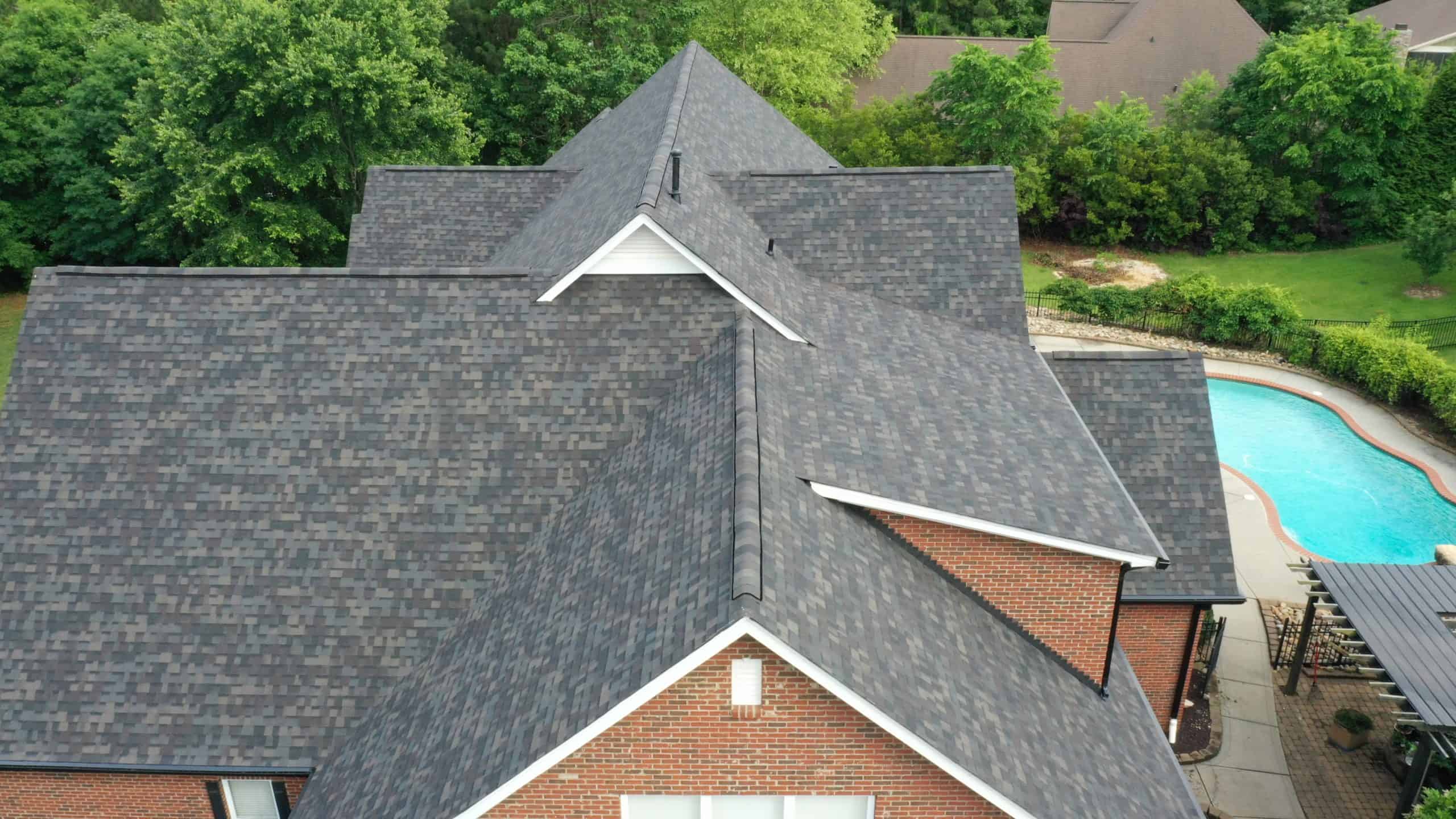 http://side%20aerial%20view%20of%20brick%20home%20with%20black%20sable%20duration%20shingles%20and%20pool