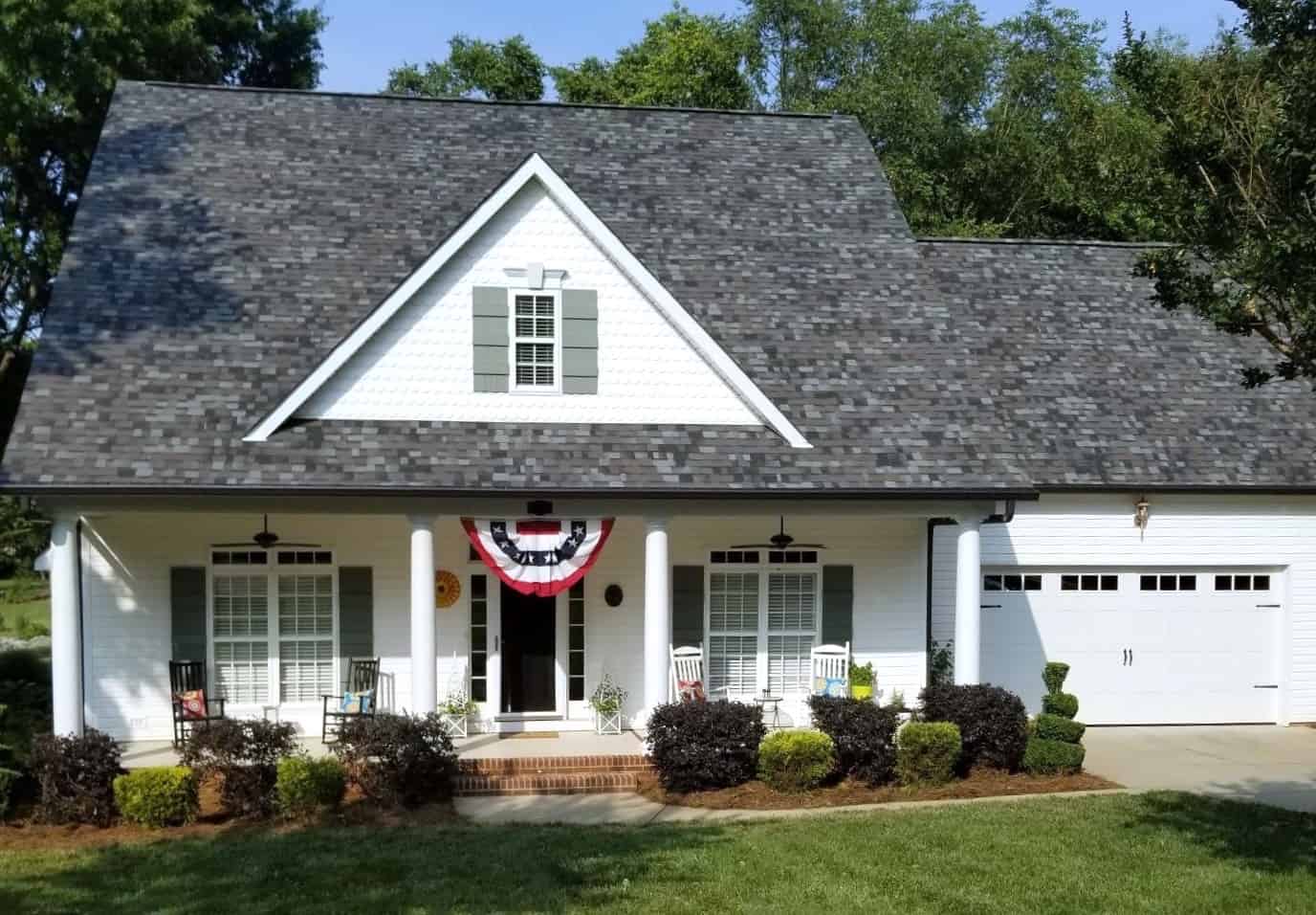 front view of white home with gray asphalt shingles
