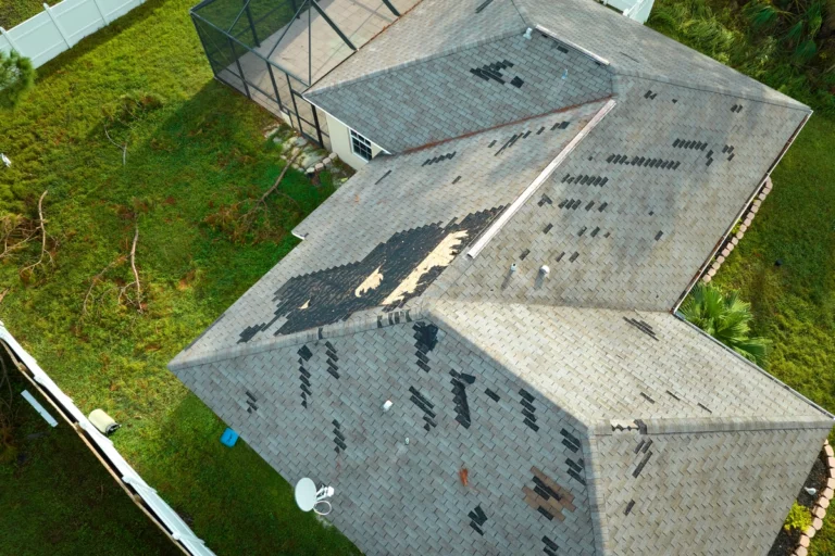 arial view of roof storm damage with missing shingles