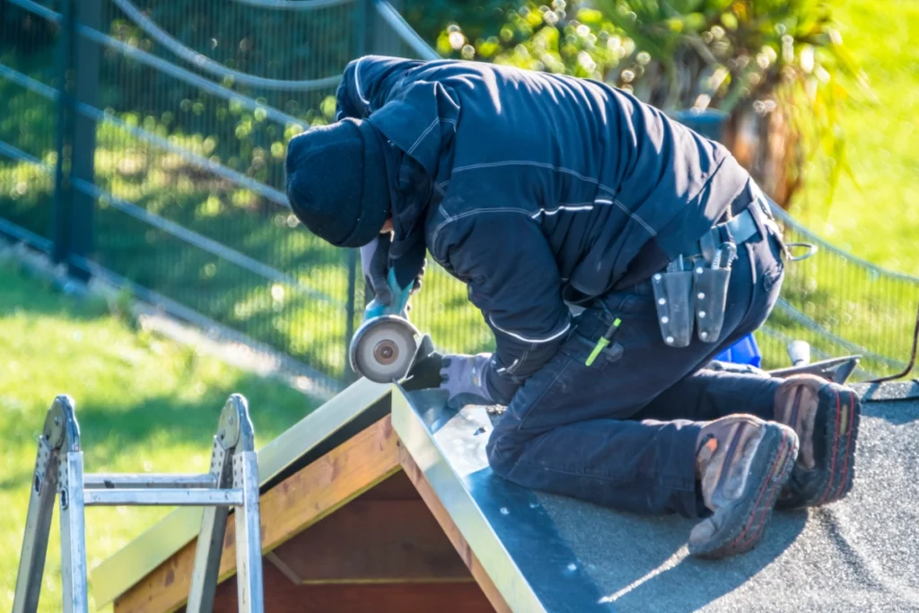 Professional roofer repairing metal frame after storm