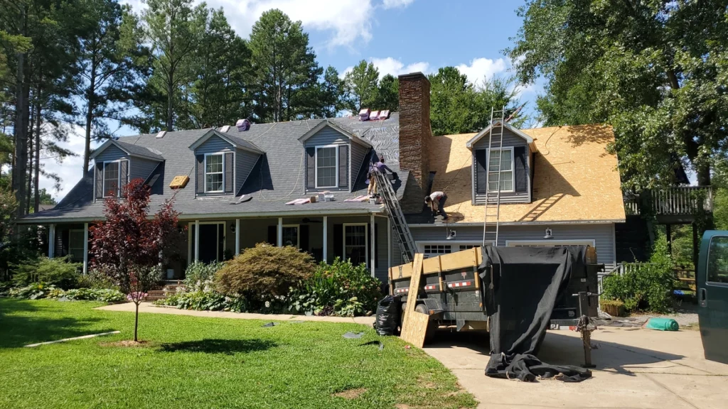 experienced team replacing the large asphalt shingle roof
