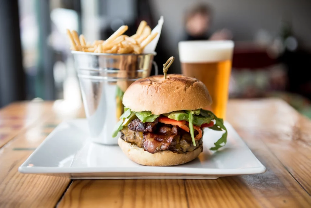 craft burger with french fries and beer at restaurant