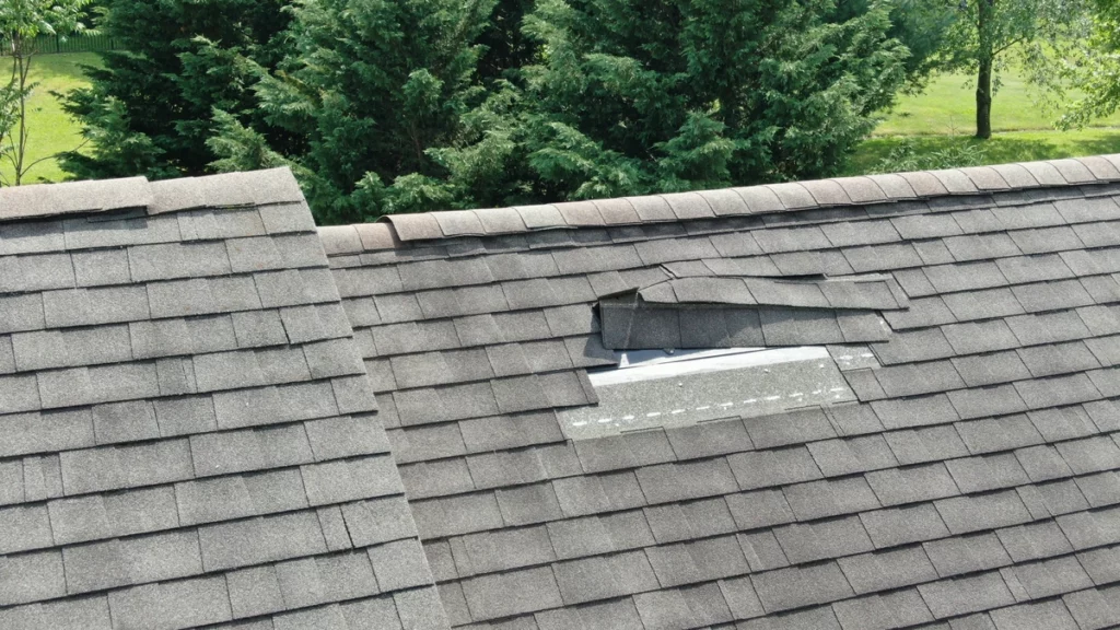 house roof with shingle damage on top