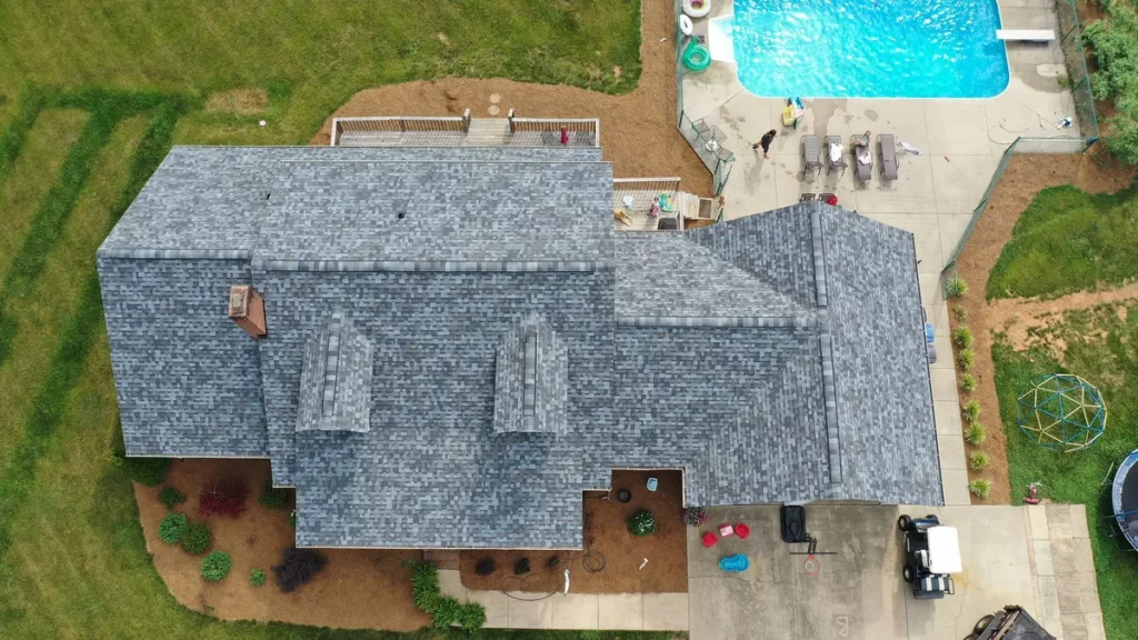 asphalt shingle roof of a large house after roof replacement process