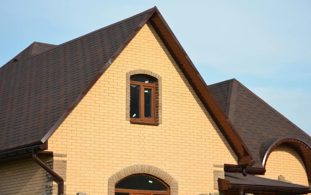 house with a beautiful natural wood color on roofing shingles