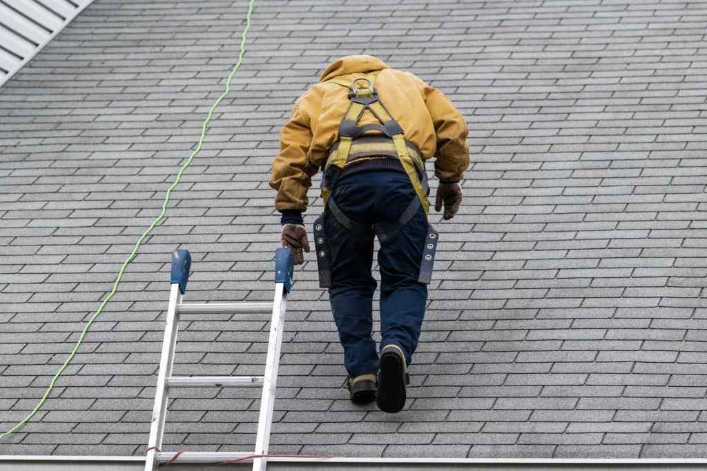contractor walking on the roof of house