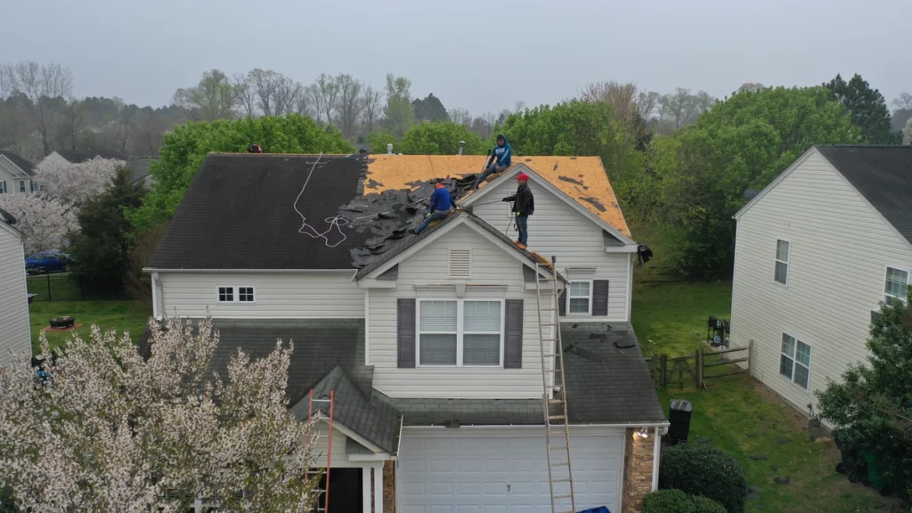 professional crew removing the damaged roofing shingles